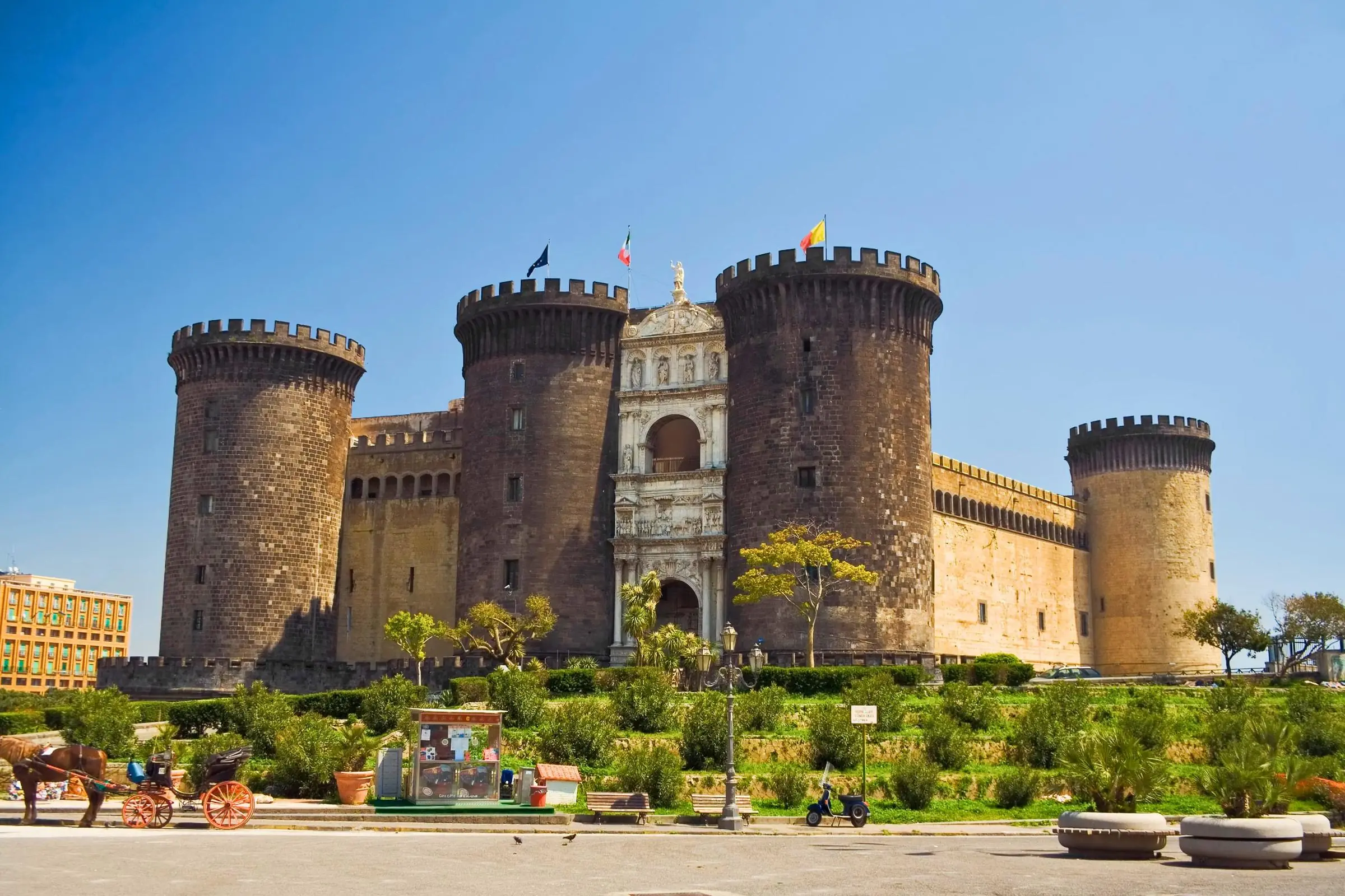 The dark volcanic stone towers and white marble Triumphal Arch of Castel Nuovo in Naples