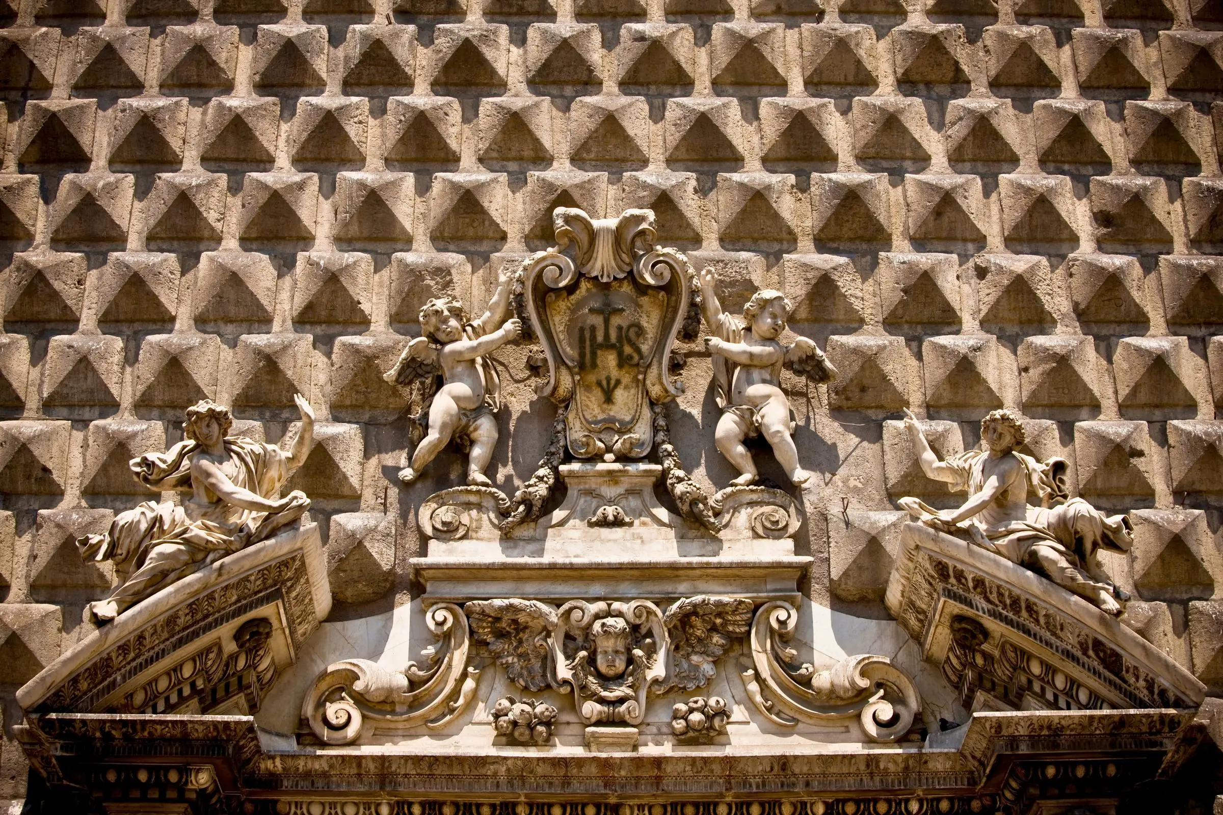The rusticated diamond-point stone facade of Chiesa del Gesù Nuovo in Naples