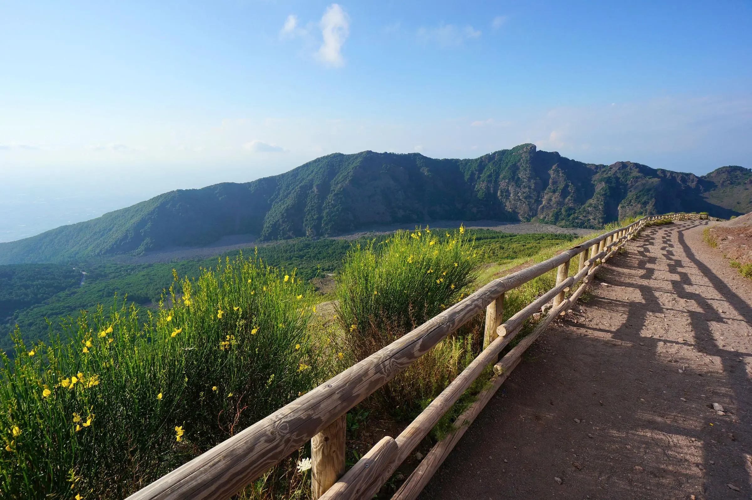 Walk along the wooden fence at the edge of the Mount Vesuvius crater