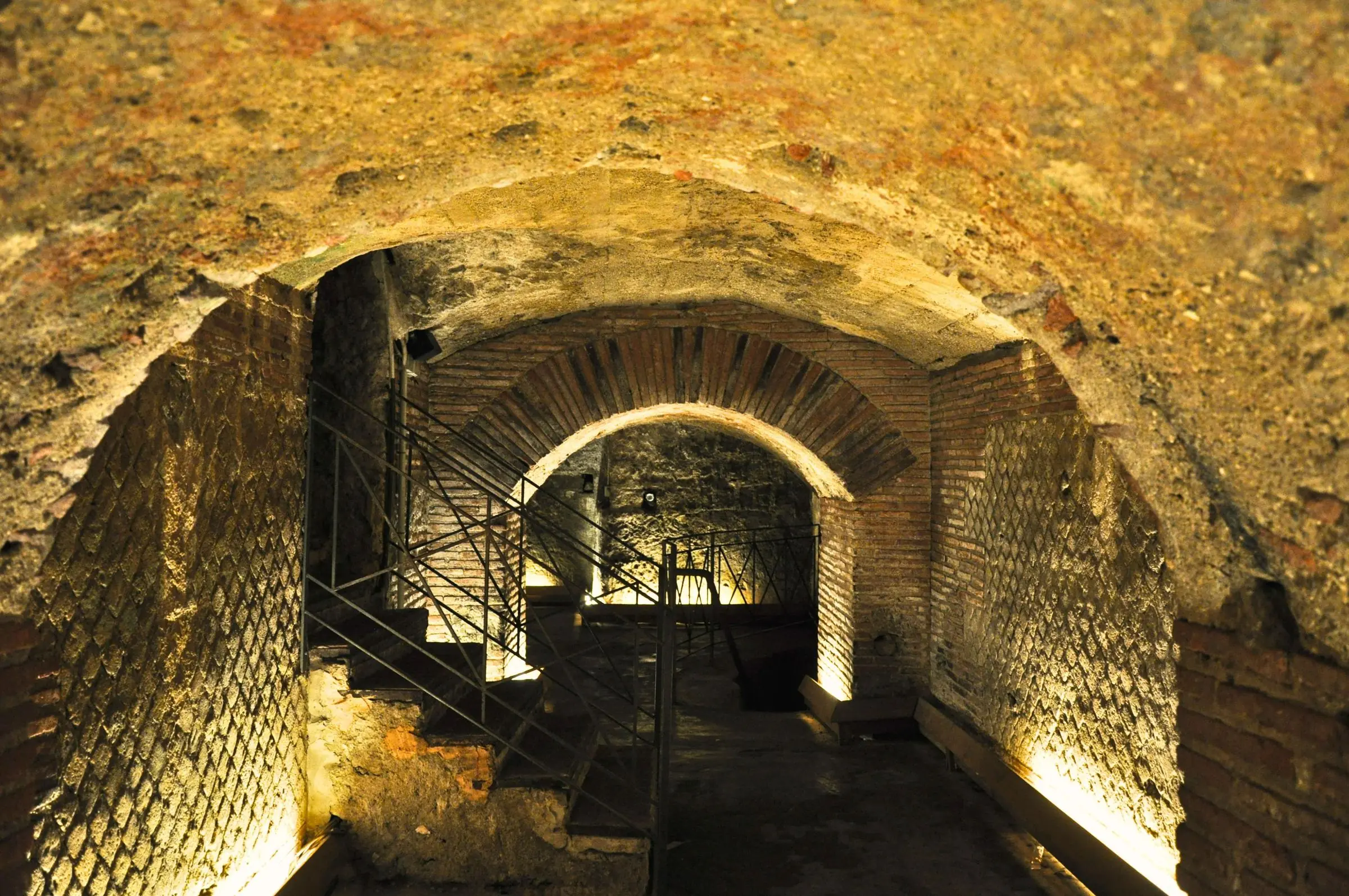 Illuminated tuff stone tunnels inside the Naples Underground